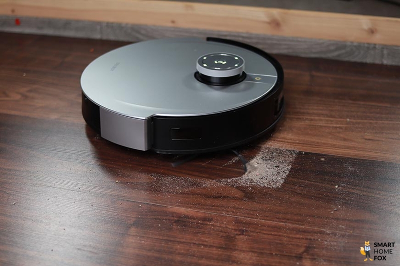 Ecovacs Deebot X1 Omni removes sand from a hard floor during a suction test